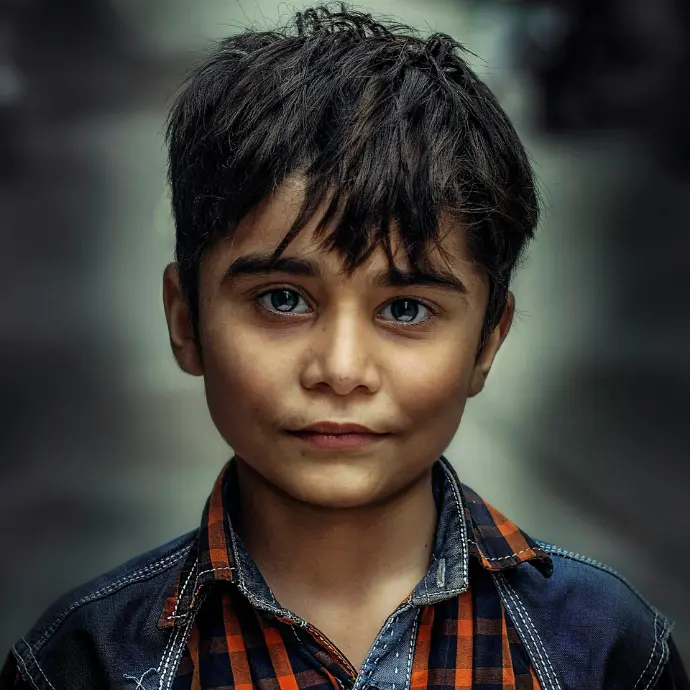 boy in blue and orange collared top